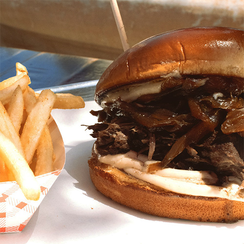 Our short rib sandwich with a side of fries, one of the most popular dishes at our ribs restaurant near Agoura Hills, CA.