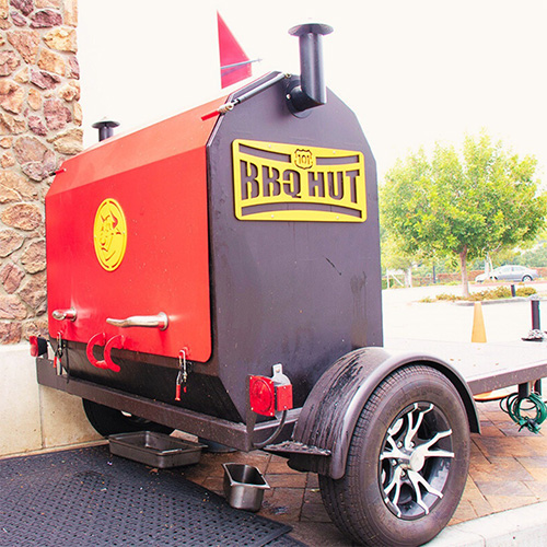 View of our smoker outside producing First Neighborhood, Westlake Village BBQ ribs.